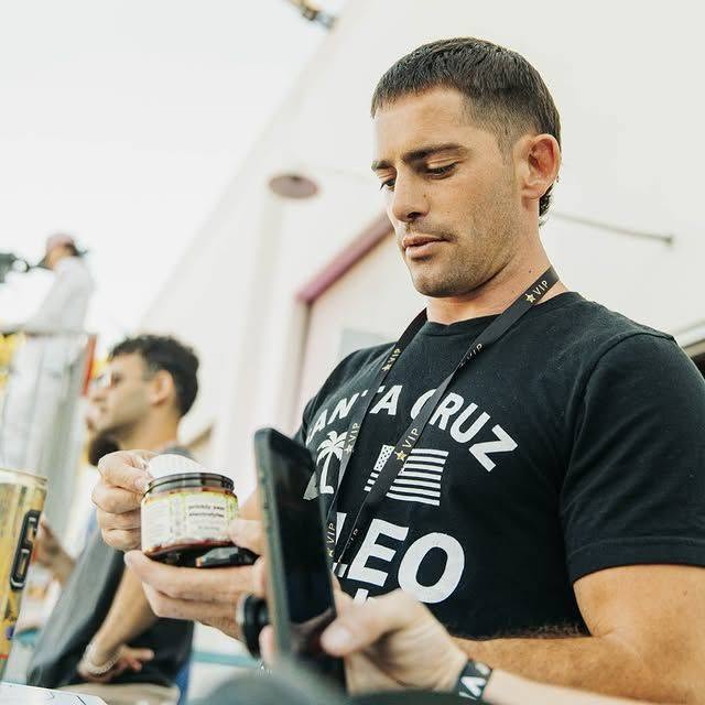 Brendan Ruh in a Santa Cruz Paleo tee holding a jar