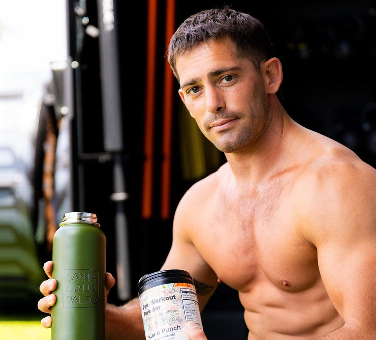 Brendan Ruh holding a Santa Cruz Paleo bottle and a tub of Pre-Workout Powder