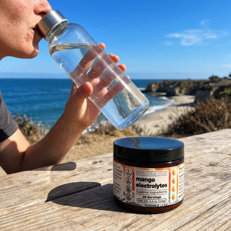 The glass bottle lifted to drink, the Mango tub in the foreground