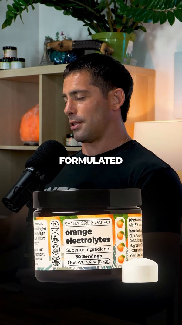 Brendan Ruh at the mic with a tub of orange electrolytes