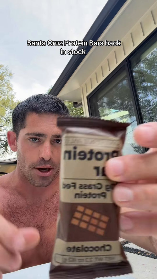 Brendan Ruh holding a chocolate Santa Cruz Paleo protein bar